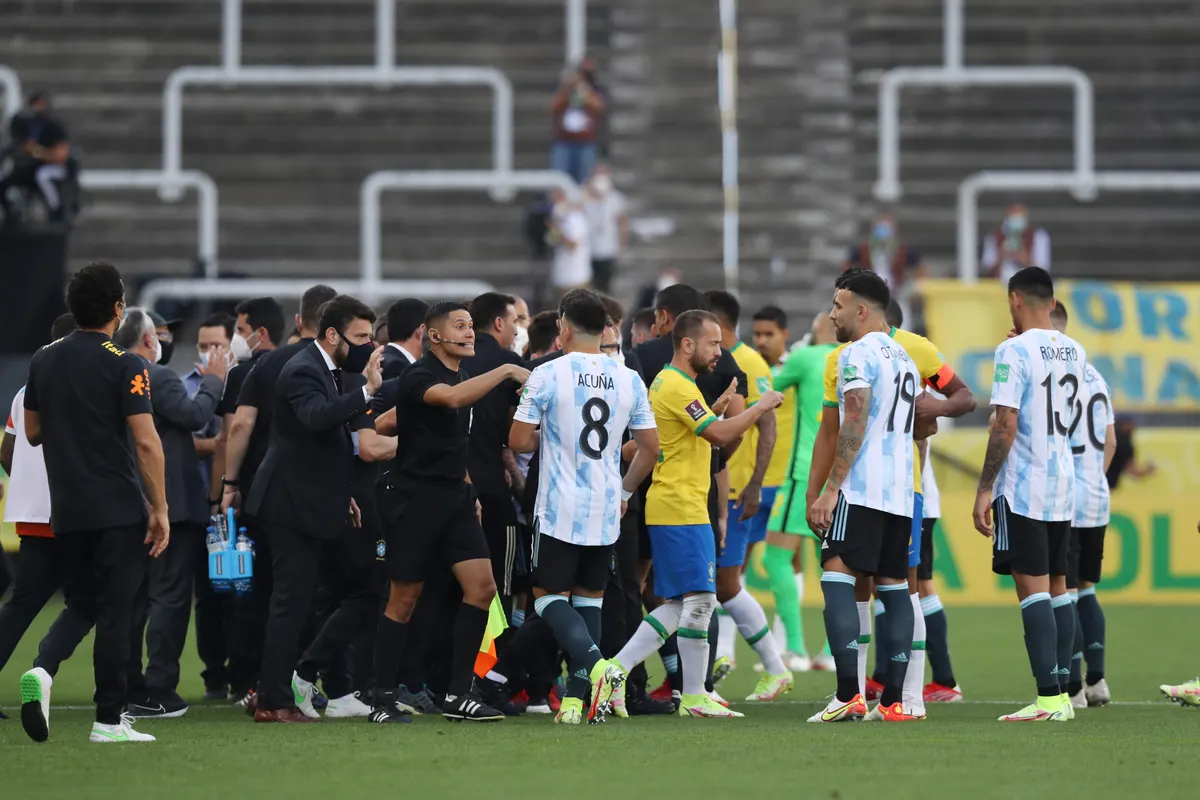 Soccer Football - World Cup - South American Qualifiers - Brazil v Argentina - Arena Corinthians, Sao Paulo, Brazil - September 5, 2021 Players and officials are seen on the pitch as play is interrupted after Brazilian health officials objected to the participation of three Argentine players they say broke quarantine rules REUTERS/Amanda Perobelli