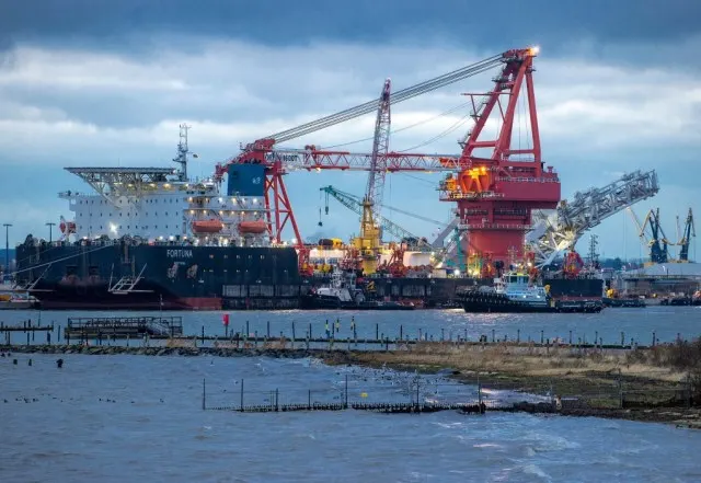 A tugboat get into position on the Russian pipe-laying vessel "Fortuna."