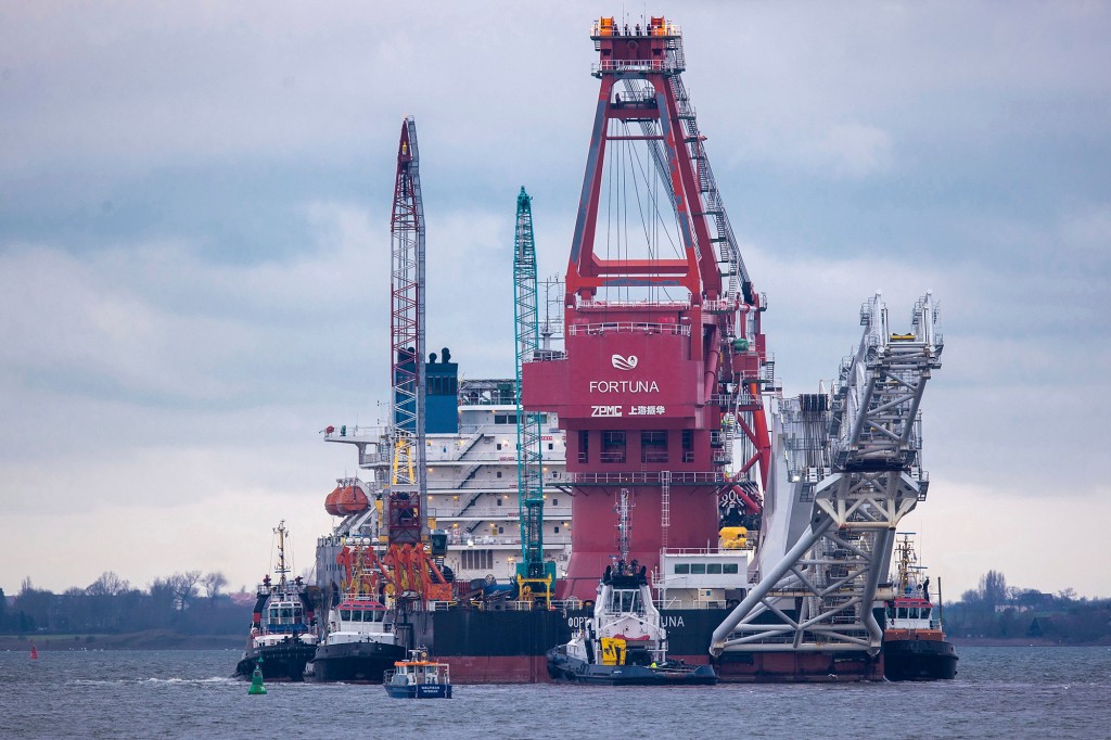 Tugboats get into position on the Russian pipe-laying vessel "Fortuna" in the port of Wismar, Germany, Jan.14, 2021.